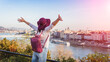 © Evgeniia Biriukova - A happy young woman enjoying her trip to Budapest, Hungary from the point from Gellert Hill during sunrise in autumn during sunrise.