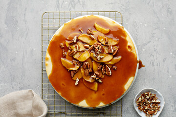 Wall Mural - Apple caramel pecan cheesecake with dripping sauce overhead shot