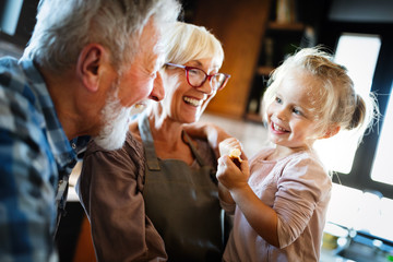 Happy grandparents having fun times with children at home