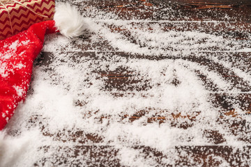 Sticker - Festive gift with bow close up on wooden background with snow