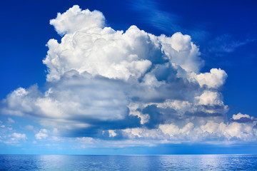 Wall Mural - White cumulus clouds over sea close up blue sky background landscape, big fluffy cloud above ocean water panorama, scenic tropical sunny summer day cloudy weather seascape view, cloudscape, copy space