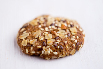 close up homemade backed cereal oat cookie on white background. macro healthy food photography