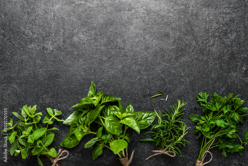 Bunch of fresh herbs from the garden. Mint, basil, parsley and rosemary herb on dark background. - obrazy, fototapety, plakaty 