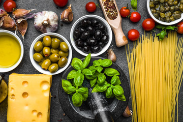 Mediterranean diet background. Ingredients for italian food cooking: pasta, basil, olive, oil, cheese, tomatoes