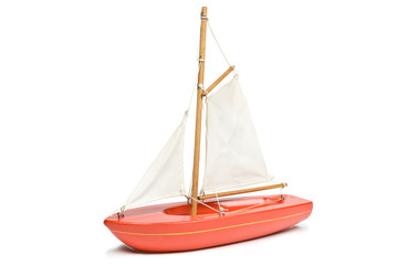 Toy red yacht isolated on a white background. Clipping path included.