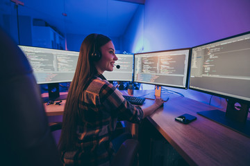 Turned photo of cheerful positive woman smiling toothily supporting clients customers in checkered shirt modifying security code