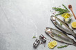 Flat lay composition with raw cutthroat trout fish on light grey marble table, space for text
