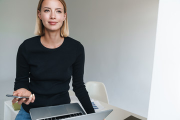 Poster - Beautiful young woman working on laptop computer