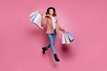 Full Length Photo Of Beautiful Model Millennial Lady Jumping High Enjoy Sales Carry Many Packs Store Wear Fluffy Jacket Retro Blue Hat Jeans Isolated Pink Background