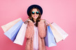 © deagreez - Photo of pretty millennial model lady carry many packs shopper enjoy tourism abroad sales wear fluffy jacket sun specs vintage blue hat isolated pink background