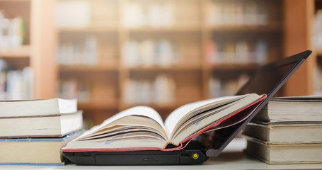 Poster - Stack of books with laptop on table
