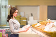 © Natalia - Woman choosing daily products at supermarket. Reading product information. Concept of information eating products, organic fruit and vegetables