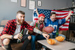 © Drobot Dean - Photo of guys screaming and drinking beer while watching sports match