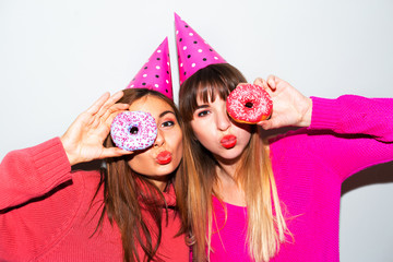 people, friends, teens and friendship concept - happy smiling pretty teenage girls with donuts makin