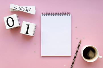 Cozy top view mockup Start new year 1 january goals on a spiral notebook with blank list for a texy. Notebook flat lay mockup cup of coffee on a pink female background