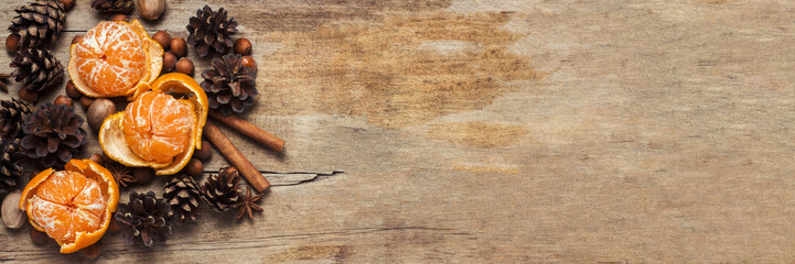 Tangerines, cones, spices on a wooden background. Сoncept of New Year and Christmas, Christmas drink Mulled wine. Flat lay, top view. Banner