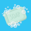 Bar of soap with foam isolated on blue