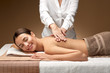 © Syda Productions - wellness, beauty and relaxation concept - beautiful young woman lying and having back massage at spa