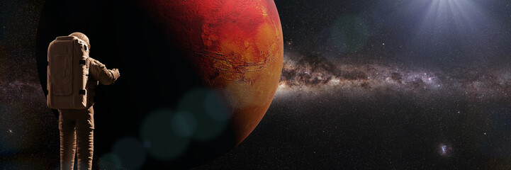 Wall Mural - astronaut waving during a space walk in orbit of planet mars