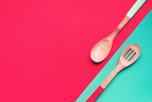Two Wooden Spoons On A Blue And Pink Background, Top View, Copy Space	