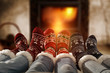 © magdal3na - Woman legs in home interior with fireplace.Woolen socks and jeans.Free space for your decoration.Christmas cold winter night.Copy space.