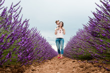 Mother And Daughter Walking Among Lavender Fields In The Summer