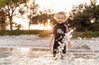 © Westend61 - Portrait of cute toddler girl standing in the sea