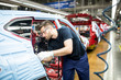 © Westend61 - Man working in modern car factory