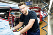 © Westend61 - Portrait of confident man working in modern car factory