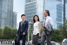 Successful Chinese Business People Walking On Street
