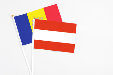 Austria and Andorra stick flags on white background. High quality fabric, miniature national flag. Peaceful global concept.White floor for copy space.