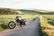 © Fabio Purroy/ADDICTIVE STOCK - Modern motorbike parked on asphalt road near grassy field on sunny day in peaceful nature