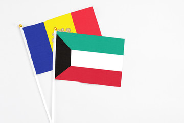 Kuwait and Andorra stick flags on white background. High quality fabric, miniature national flag. Peaceful global concept.White floor for copy space.