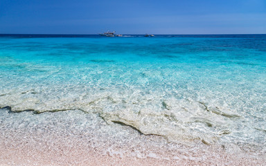 Wall Mural - The natural beach of Sardinia island, Italy. Crystal clear water, blue sky, calm and tranquility. Copy space.