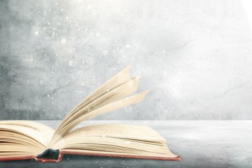 Wall Mural - open book on old wooden table.