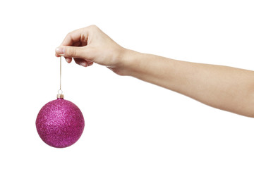 Christmas pink toy ball for the Christmas tree іn hand isolated on a white background.