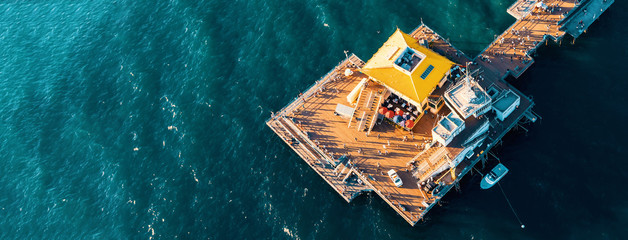 Wall Mural - Aerial view of a pier in the pacific ocean on the California coast