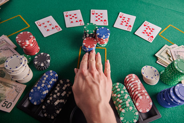 A straight flush, laid out on the table and a lot of chips. Poker, Casino, Winning combination. Player raises bets and wins