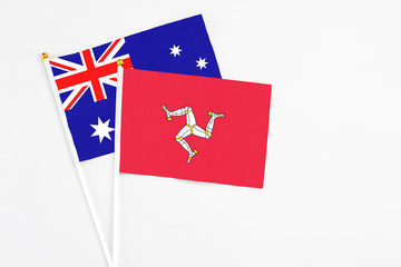 Isle Of Man and Australia stick flags on white background. High quality fabric, miniature national flag. Peaceful global concept.White floor for copy space.