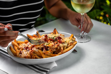 Nachos cheese loaded french fries - mexican cuisine, outside restaurant in a summer day  