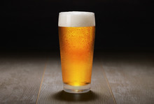 A Fresh Pint Of India Pale Ale IPA Craft Beer Served In A Cold Pint Glass At A Brewery, Black Background