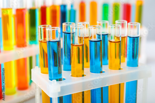 Test tubes with colorful samples in laboratory, closeup