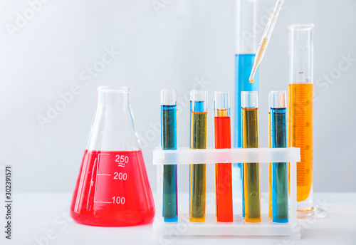 Test tubes and flask with colorful samples in laboratory