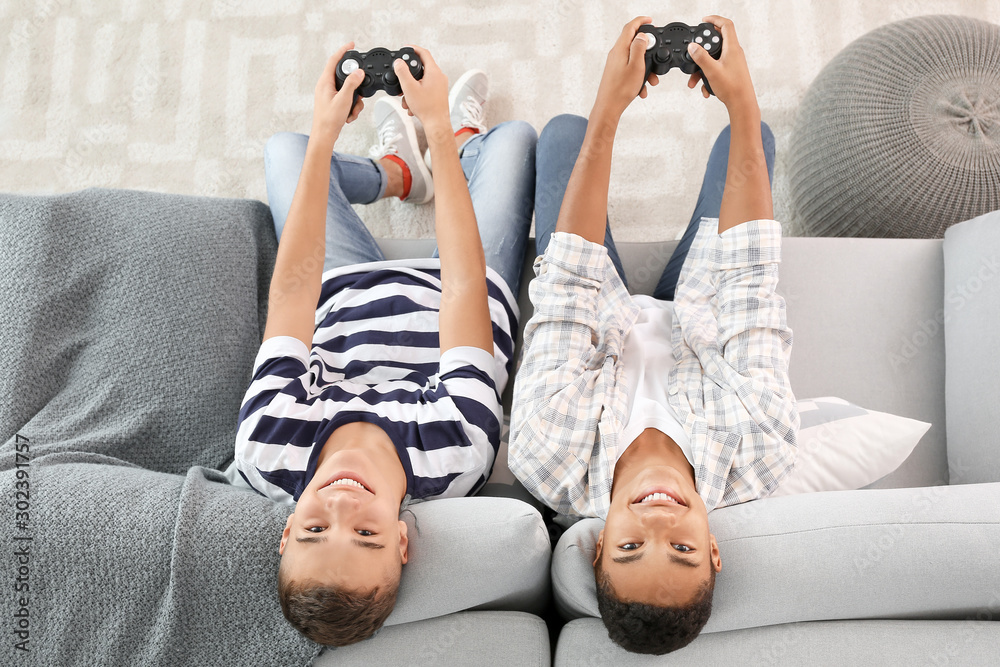 Teenager boys playing video games at home, top view - obrazy, fototapety, plakaty 