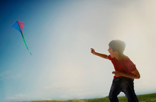 Portrait Of A Happy Young Boy Flying A Kite. (Children) 	