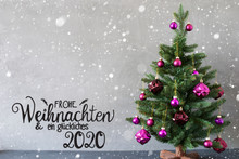 German Calligraphy Frohe Weihnachten Und Ein Glueckliches 2020 Mean Merry Christmas And A Happy 2020. Tree With Purple Christmas Ball Ornament. Gray Background With Snowflakes