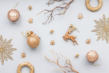 gold christmas decoration on blue pastel background, top view, flat lay