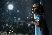 Child Looks Out The Window On Christmas Day