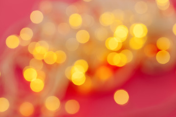 illuminated garland lights on bright pink background