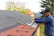 Modern roof shingles tiles. Soft asphalt roof cover and roofing construction for a small house in the garden. Easy roofing repair. Czech republic, Europe.